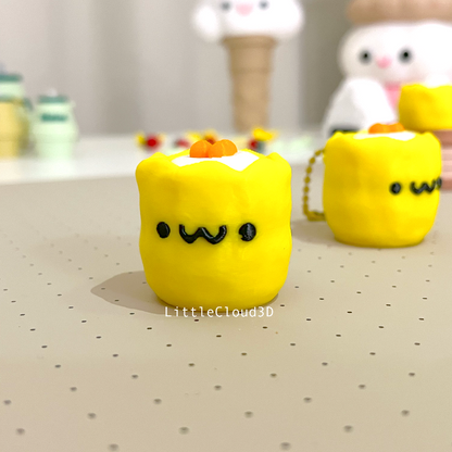 Two yellow 3d printed siu mai clickers with smiley faces on them.